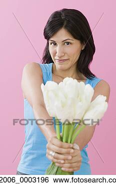 Stock Photo - studio shot of 
hispanic woman 
holding tulips. 
fotosearch - search 
stock photos, 
pictures, images, 
and photo clipart