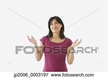 Picture - studio shot of 
hispanic woman 
looking up with 
hands in air. 
fotosearch - search 
stock photos, 
pictures, images, 
and photo clipart