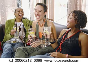 Stock Photo - three women laughing 
and drinking on 
sofa. fotosearch 
- search stock 
photos, pictures, 
images, and photo 
clipart