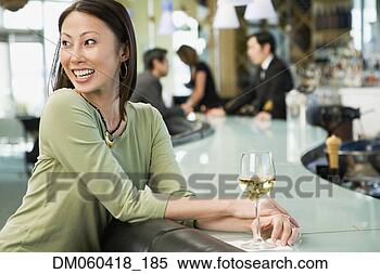 Stock Image - woman at bar with 
glass of wine. 
fotosearch - search 
stock photos, 
pictures, images, 
and photo clipart