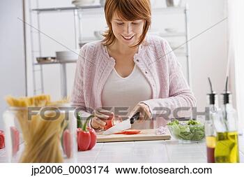 Stock Photo - woman slicing 
tomatoes. fotosearch 
- search stock 
photos, pictures, 
images, and photo 
clipart