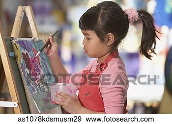 Stock Photograph - young asian girl 
painting at easel. 
fotosearch - search 
stock photos, 
pictures, images, 
and photo clipart