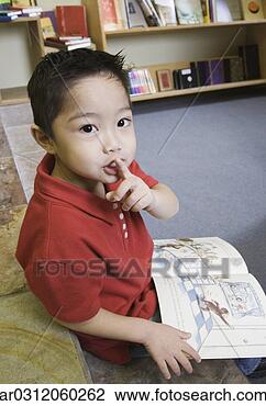 Stock Photo - young boy gesturing 
for silence in 
library. fotosearch 
- search stock 
photos, pictures, 
images, and photo 
clipart