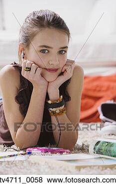 Stock Photo - young girl listening 
to music on floor. 
fotosearch - search 
stock photos, 
pictures, images, 
and photo clipart