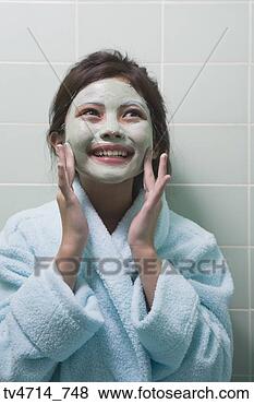 Stock Photo - young hispanic 
girl applying 
facial mask. fotosearch 
- search stock 
photos, pictures, 
images, and photo 
clipart
