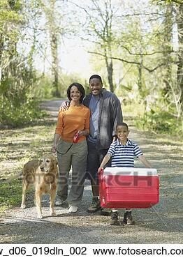Stock Photo - african family 
with cooler in 
woods. fotosearch 
- search stock 
photos, pictures, 
images, and photo 
clipart