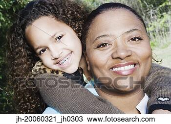 Stock Photo - african mother 
and daughter hugging 
outdoors. fotosearch 
- search stock 
photos, pictures, 
images, and photo 
clipart