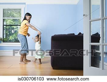 Stock Photo - african mother 
and young daughter 
dancing in livingroom. 
fotosearch - search 
stock photos, 
pictures, images, 
and photo clipart