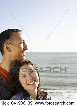 Stock Photograph - asian couple on 
the beach. fotosearch 
- search stock 
photos, pictures, 
images, and photo 
clipart