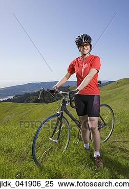 Stock Image - asian woman wearing 
bicycle gear with 
bicycle. fotosearch 
- search stock 
photos, pictures, 
images, and photo 
clipart