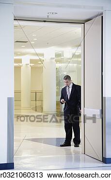 Stock Photo - businessman with 
mp3 player in 
doorway. fotosearch 
- search stock 
photos, pictures, 
images, and photo 
clipart