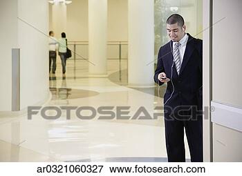 Picture - businessman with 
mp3 player in 
doorway. fotosearch 
- search stock 
photos, pictures, 
images, and photo 
clipart