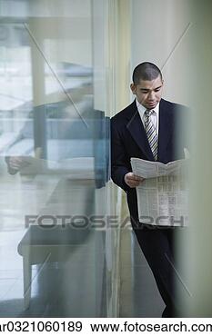 Stock Photograph - businessman with 
newspaper leaning 
on glass wall. 
fotosearch - search 
stock photos, 
pictures, images, 
and photo clipart