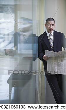 Stock Photo - businessman with 
newspaper leaning 
on glass wall. 
fotosearch - search 
stock photos, 
pictures, images, 
and photo clipart