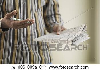Picture - close up of african 
man with pen and 
newspaper. fotosearch 
- search stock 
photos, pictures, 
images, and photo 
clipart