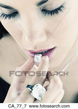 Picture - close up of woman 
holding diamond 
up to mouth. fotosearch 
- search stock 
photos, pictures, 
images, and photo 
clipart