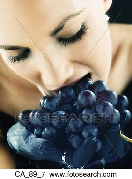 Picture - close up of woman 
eating bunch of 
grapes. fotosearch 
- search stock 
photos, pictures, 
images, and photo 
clipart