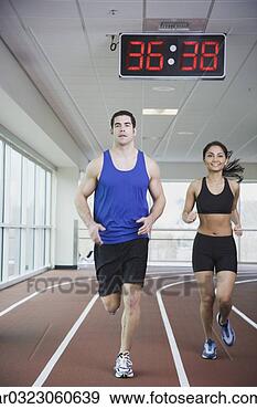 Stock Photograph - couple running 
on indoor track. 
fotosearch - search 
stock photos, 
pictures, images, 
and photo clipart