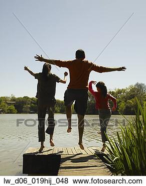 Stock Photo - family jumping 
off dock. fotosearch 
- search stock 
photos, pictures, 
images, and photo 
clipart