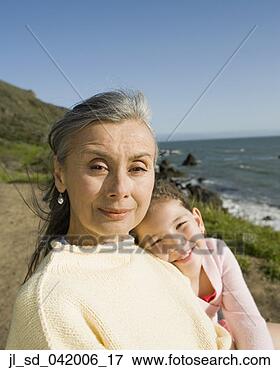 Picture - grandmother and 
granddaughter 
hugging at ocean. 
fotosearch - search 
stock photos, 
pictures, images, 
and photo clipart
