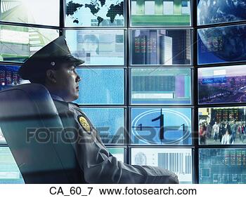 Picture - male security 
guard sitting 
in front of monitor 
screens. fotosearch 
- search stock 
photos, pictures, 
images, and photo 
clipart