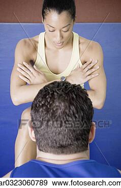 Stock Photograph - male trainer helping 
woman do sit ups. 
fotosearch - search 
stock photos, 
pictures, images, 
and photo clipart