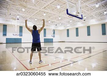 Stock Image - man cheering on 
basketball court. 
fotosearch - search 
stock photos, 
pictures, images, 
and photo clipart