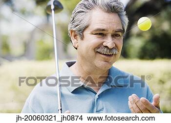 Stock Photo - middle-aged man 
with golf club 
and golf ball. 
fotosearch - search 
stock photos, 
pictures, images, 
and photo clipart