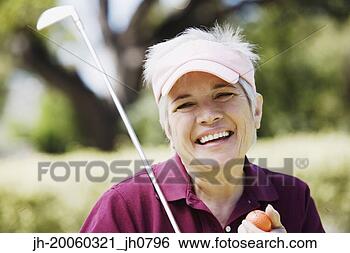 Stock Photo - middle-aged woman 
with golf club 
and golf ball. 
fotosearch - search 
stock photos, 
pictures, images, 
and photo clipart