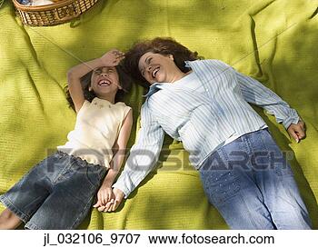 Picture - mother and daughter 
laying on picnic 
blanket. fotosearch 
- search stock 
photos, pictures, 
images, and photo 
clipart