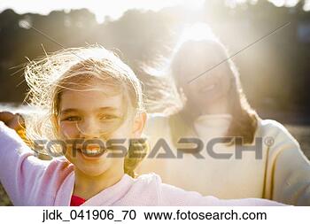 Stock Photography - mother and daughter 
smiling for the 
camera. fotosearch 
- search stock 
photos, pictures, 
images, and photo 
clipart
