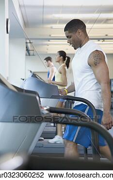 Stock Photo - people on treadmills 
at gym. fotosearch 
- search stock 
photos, pictures, 
images, and photo 
clipart