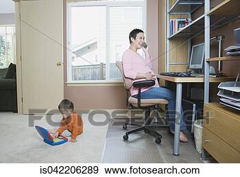Stock Photograph - pregnant woman 
working at home 
with young son. 
fotosearch - search 
stock photos, 
pictures, images, 
and photo clipart