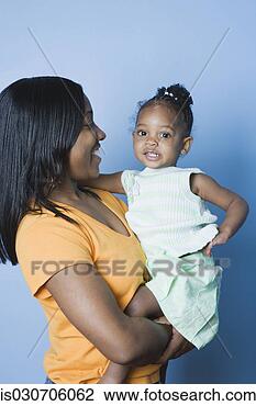 Stock Photo - studio shot of 
african mother 
holding young 
daughter. fotosearch 
- search stock 
photos, pictures, 
images, and photo 
clipart