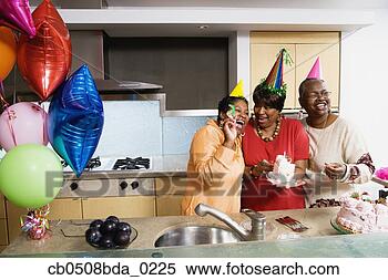Stock Image - three middle-aged 
african women 
at birthday party. 
fotosearch - search 
stock photos, 
pictures, images, 
and photo clipart