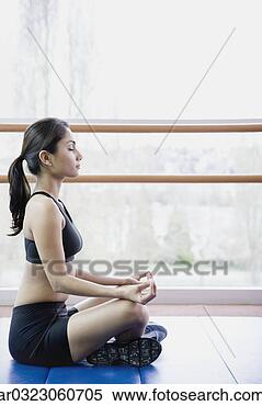 Stock Image - woman meditating 
indoors. fotosearch 
- search stock 
photos, pictures, 
images, and photo 
clipart