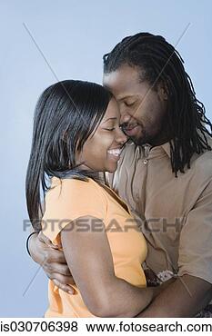 Stock Photo - young african 
couple hugging 
with eyes closed. 
fotosearch - search 
stock photos, 
pictures, images, 
and photo clipart