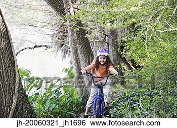 Stock Photo - young girl on 
bicycle in woods. 
fotosearch - search 
stock photos, 
pictures, images, 
and photo clipart