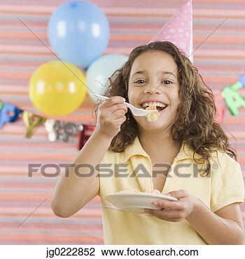 Stock Photo - young girl eating 
cake at birthday 
party. fotosearch 
- search stock 
photos, pictures, 
images, and photo 
clipart