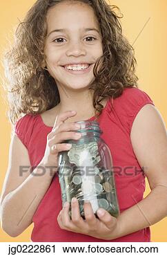 Stock Photography - young girl holding 
jar full of money. 
fotosearch - search 
stock photos, 
pictures, images, 
and photo clipart