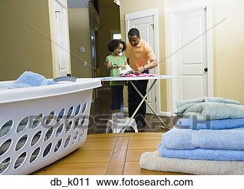 Stock Photography - african father 
and daughter using 
iron in laundry 
room. fotosearch 
- search stock 
photos, pictures, 
images, and photo 
clipart