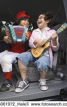 Stock Photo - brother and sister 
playing toy instruments 
in back of car. 
fotosearch - search 
stock photos, 
pictures, images, 
and photo clipart