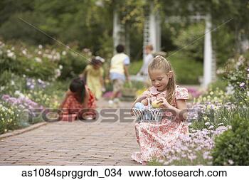 Stock Photo - children gathering 
easter eggs in 
garden. fotosearch 
- search stock 
photos, pictures, 
images, and photo 
clipart