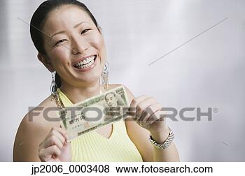 Stock Photo - close up of asian 
woman holding 
money. fotosearch 
- search stock 
photos, pictures, 
images, and photo 
clipart