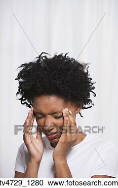 Stock Photography - close up of young 
african woman 
rubbing temples. 
fotosearch - search 
stock photos, 
pictures, images, 
and photo clipart