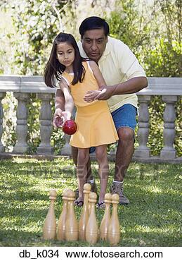 Stock Photo - hispanic father 
helping daughter 
play lawn bowling. 
fotosearch - search 
stock photos, 
pictures, images, 
and photo clipart