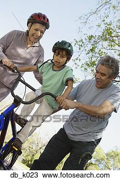 Stock Photo - hispanic grandparents 
helping grandson 
ride bicycle. 
fotosearch - search 
stock photos, 
pictures, images, 
and photo clipart