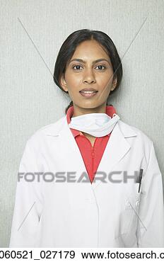 Stock Photograph - indian female 
dentist in lab 
coat and surgical 
mask. fotosearch 
- search stock 
photos, pictures, 
images, and photo 
clipart