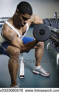 Stock Photo - man lifting weights 
at gym. fotosearch 
- search stock 
photos, pictures, 
images, and photo 
clipart