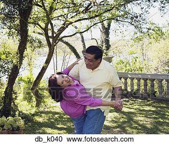 Stock Photography - middle-aged hispanic 
couple dancing 
outdoors. fotosearch 
- search stock 
photos, pictures, 
images, and photo 
clipart